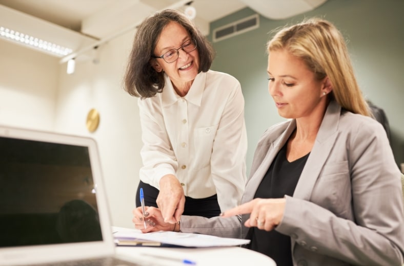 Employee helping a coworker