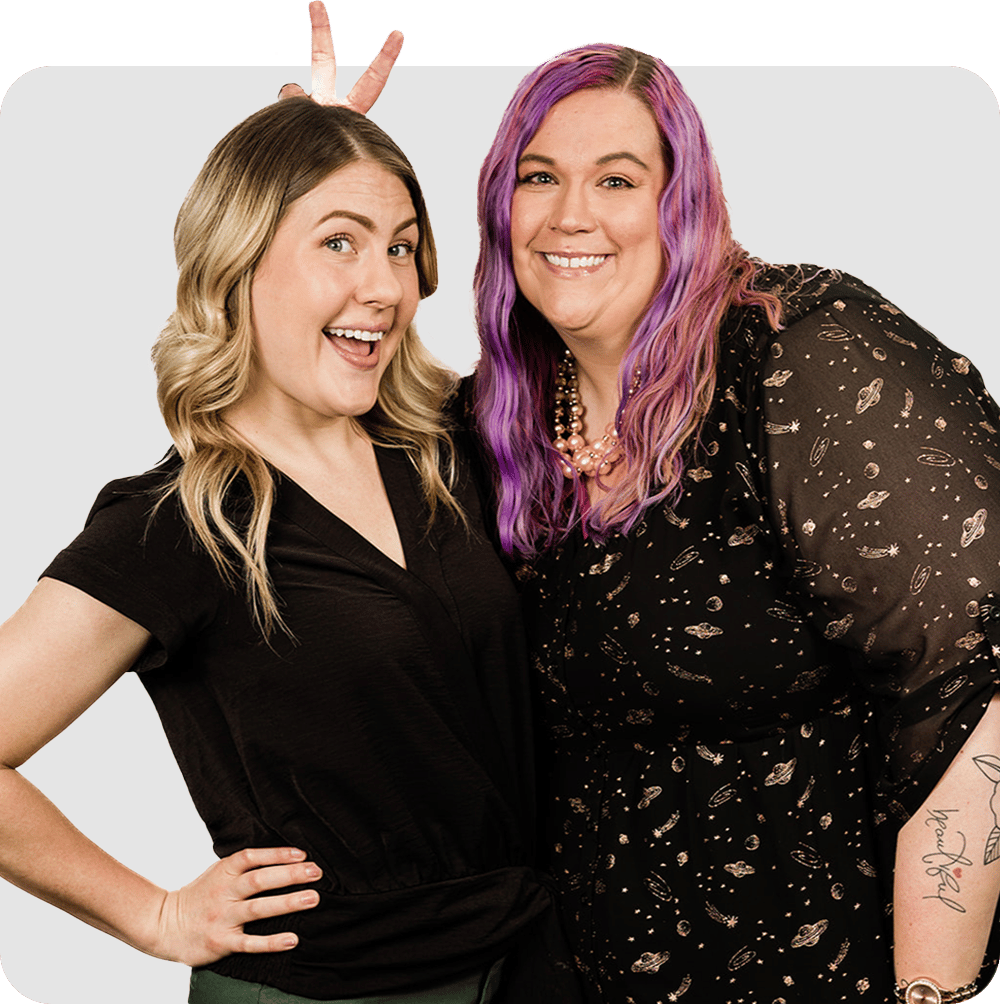 Two professional women posing for a picture