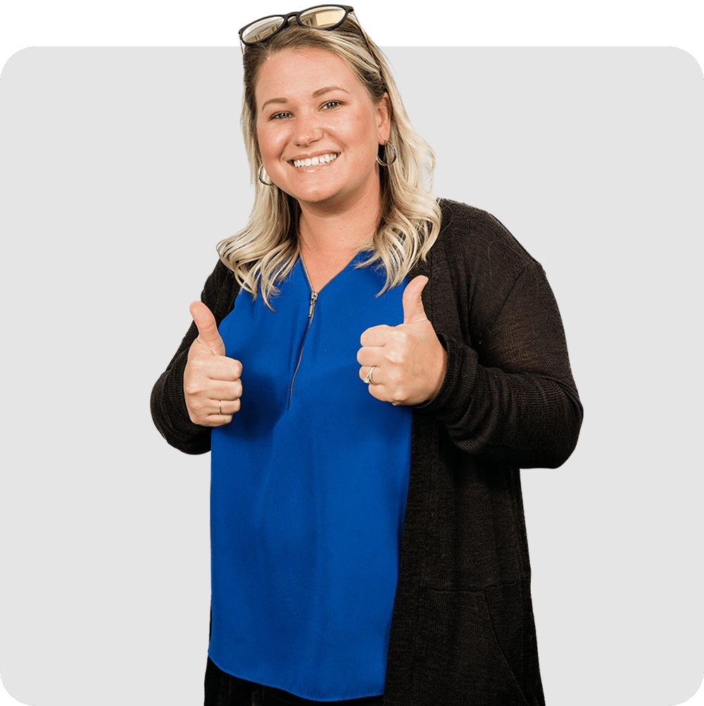 A professional woman giving a thumbs-up