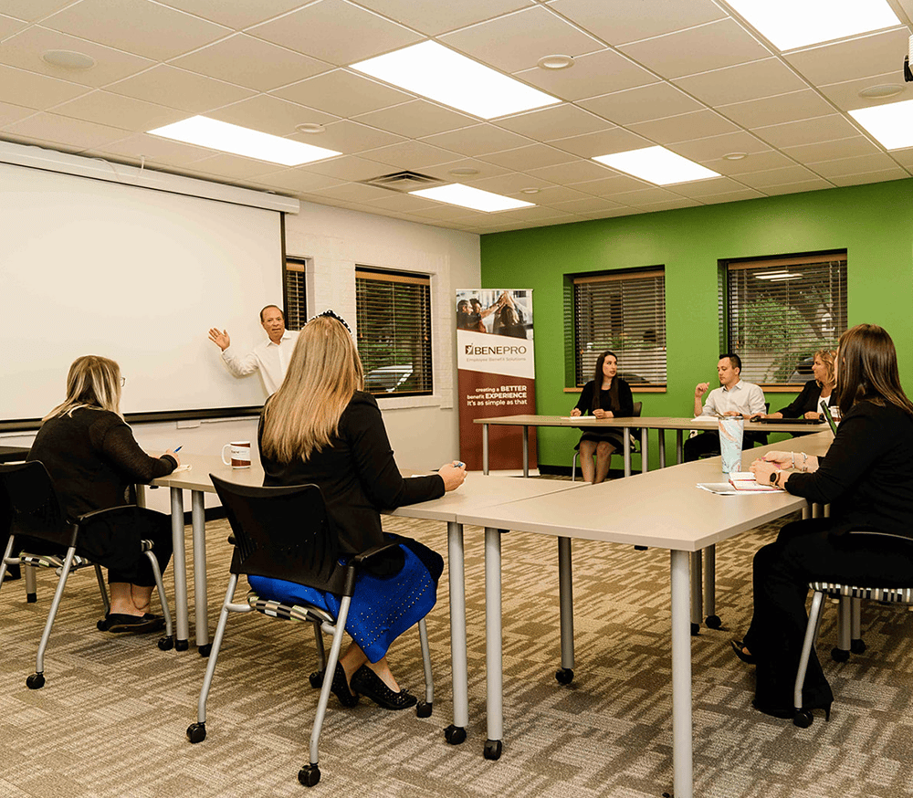 a group of people sitting at a table in a room